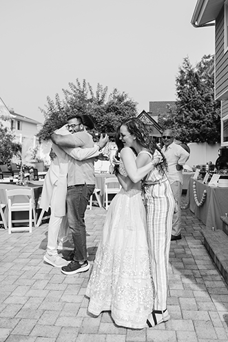Bride and guest hugging