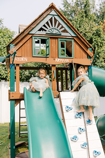 Nieces of bride playing on jungle gym