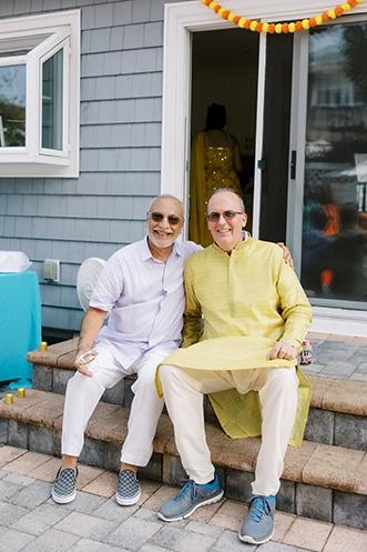 Uncle of groom and father of bride smiling at camera
