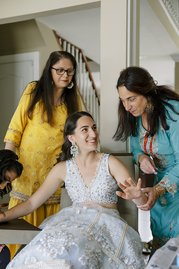 Bride getting henna and talking with family