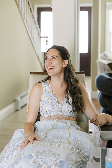 Bride getting henna laughing
